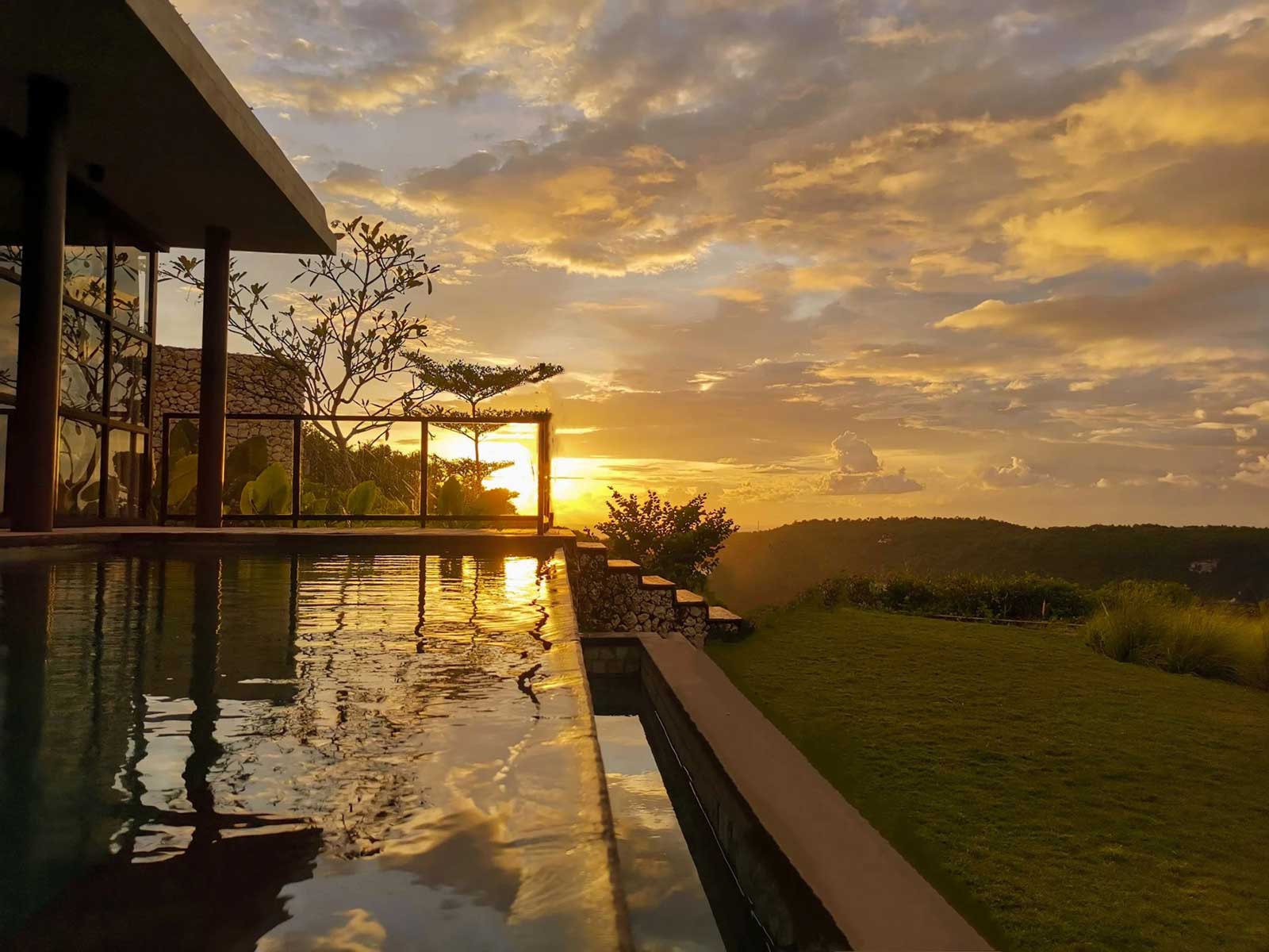 Villa infinity pool at sunset over the hills of Nusa Penida at MAUA Nusa Penida, Bali