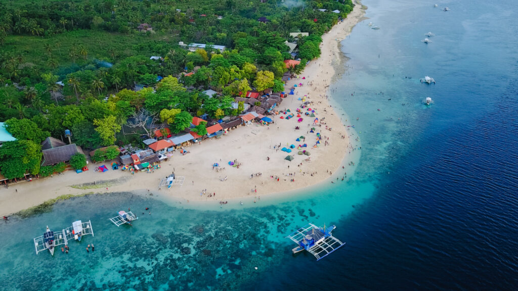 Beachfront lawn and setting at The Meru Sanur on Sanur Beach