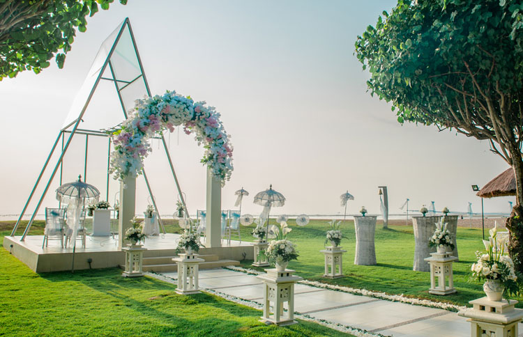 The glass Mirage Chapel at Grand Mirage Resort in Tanjung Benoa, a triangular semi open-air structure set in the garden with the ocean beyond