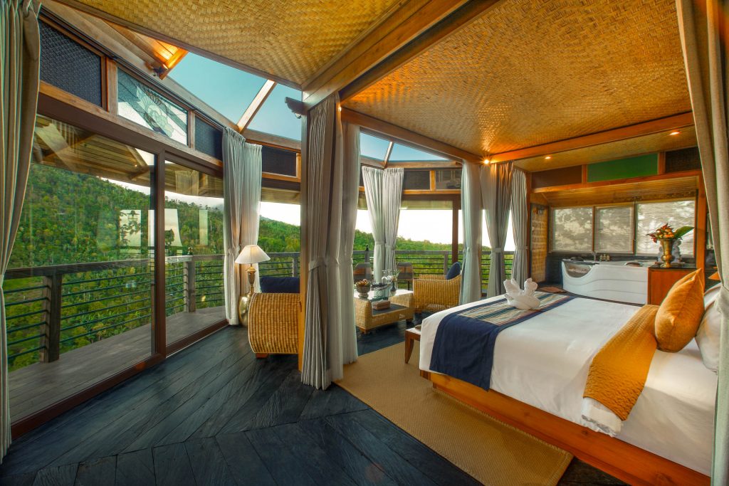 Floating villa bedroom with a glass roof, jacuzzi and a private deck over the jungle at Munduk Heaven Luxury Villas, Munduk, Bali