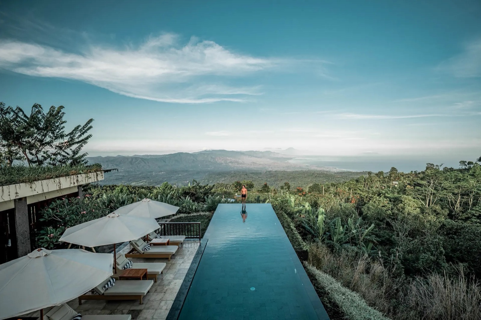 The infinity pool at Munduk Moding Plantation looking north over the plantation to the coast and the Bali Sea, Munduk, Bali