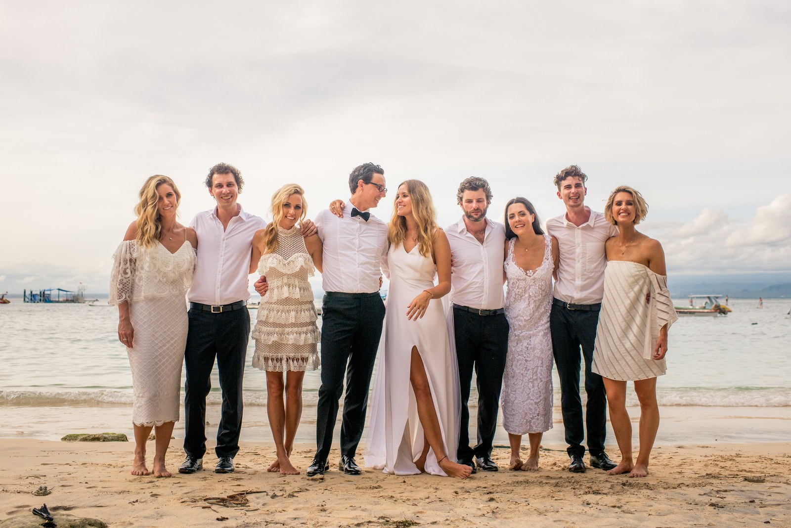 Wedding party barefoot on the beach in front of Ohana's, Nusa Lembongan, Bali