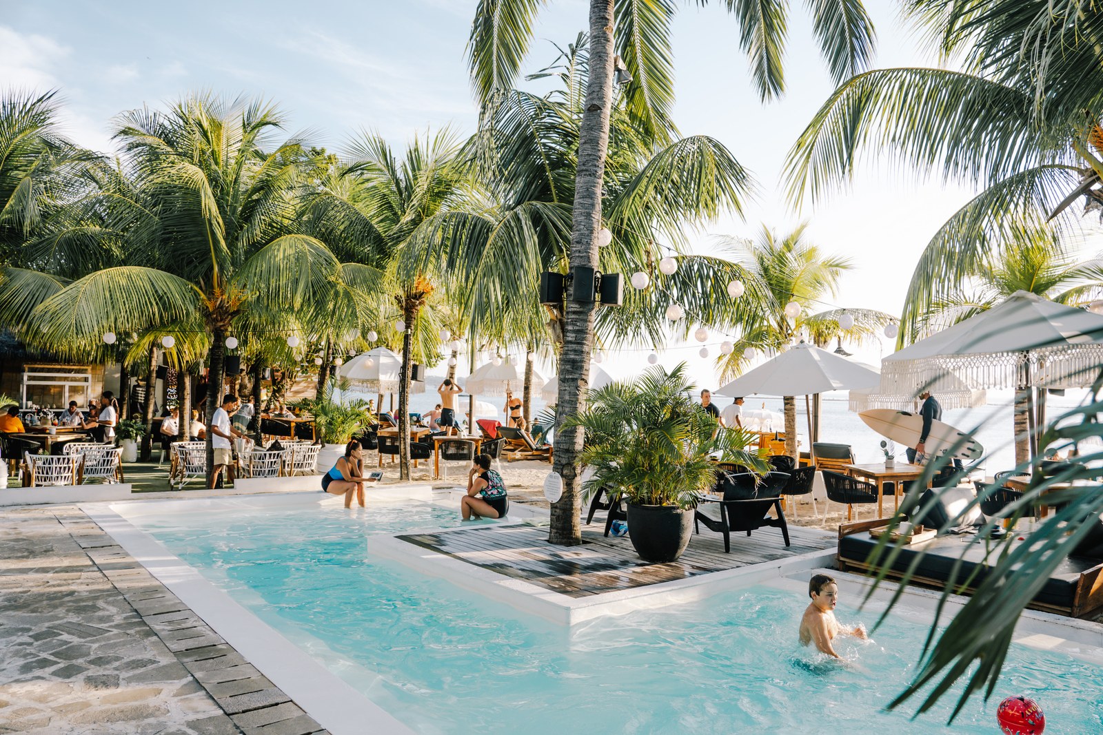 Resort pool and palms beside the beach club at Ohana's, Jungut Batu, Nusa Lembongan, Bali