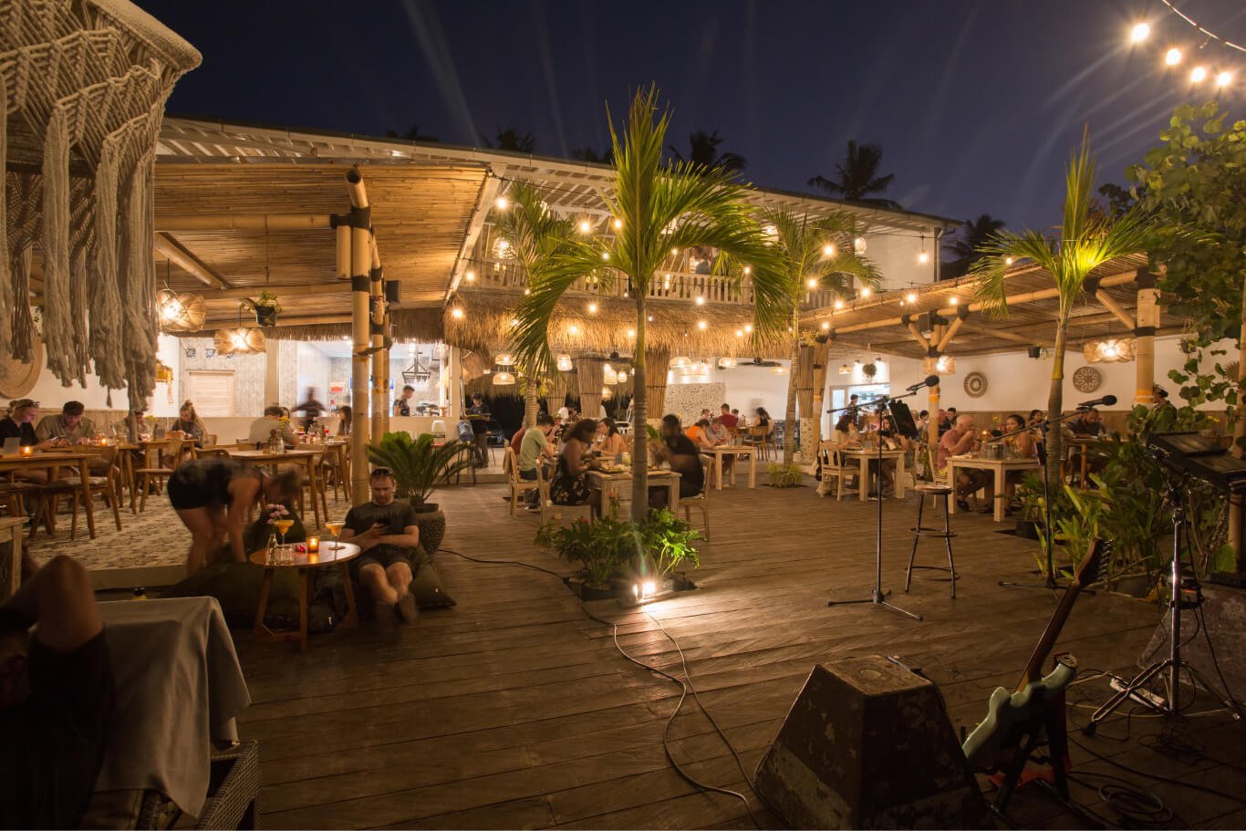 Evening on the lantern-lit deck with a live music setup at Penida Colada on Nusa Penida, Bali