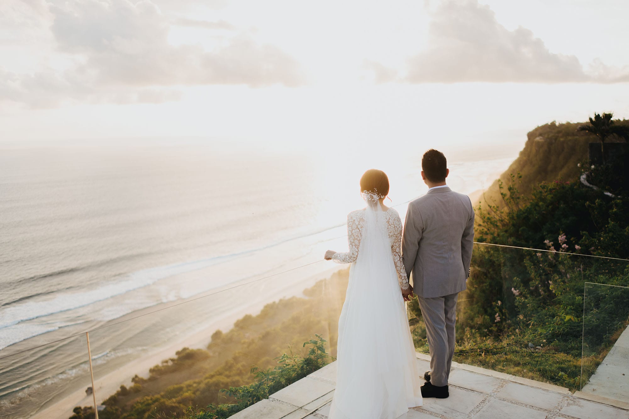 The cliff-top lawn and 180-degree ocean view at Plenilunio Villa above Nunggalan Beach in Pecatu, Uluwatu