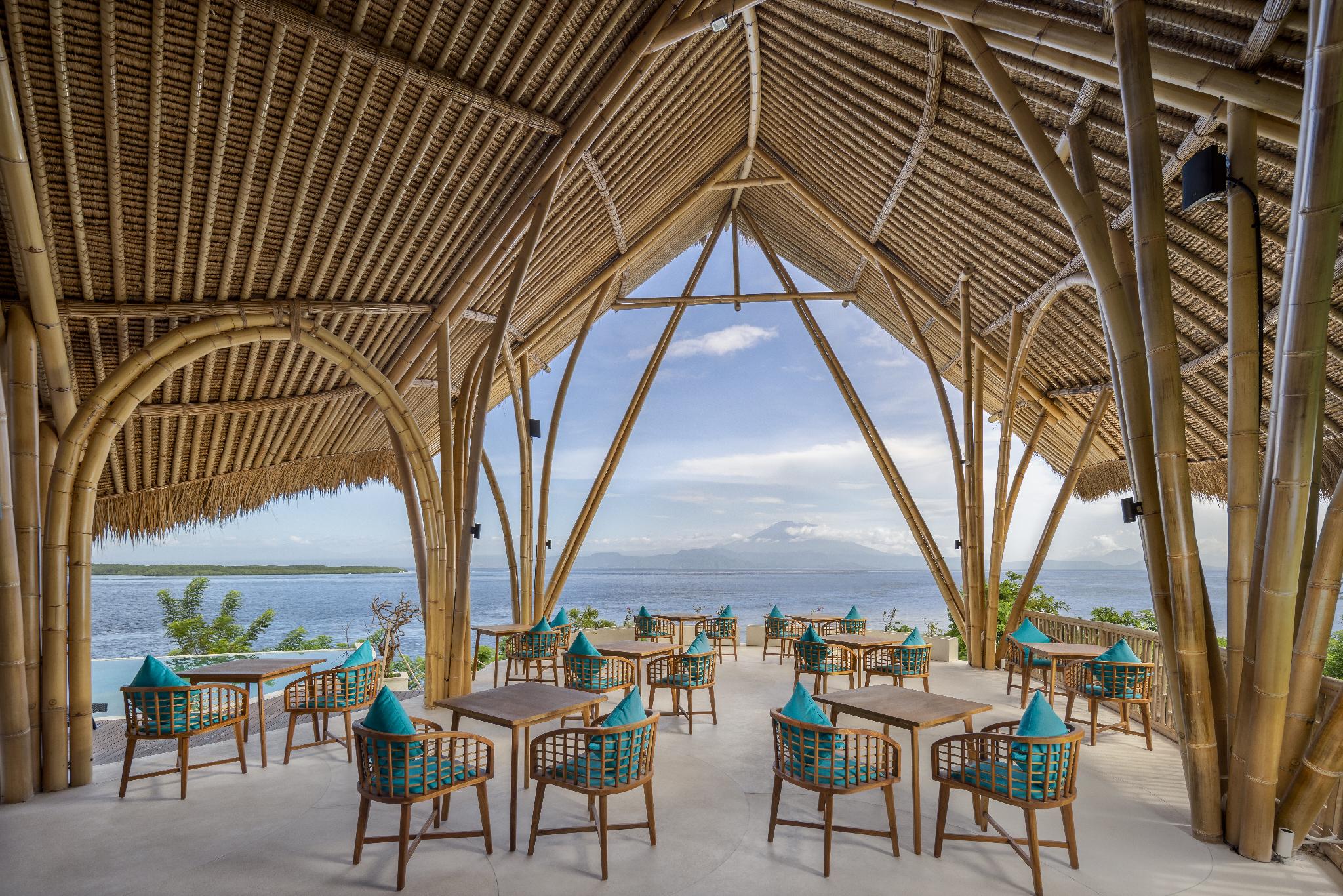 Bamboo-vaulted Acropora Bar and Restaurant looking across the strait to Mount Agung at Pramana Natura Nusa Penida, Bali