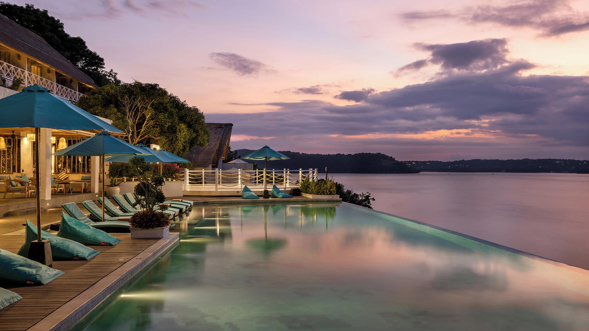 Cliffside infinity pool and terrace at dusk at Pramana Natura Nusa Penida, Bali