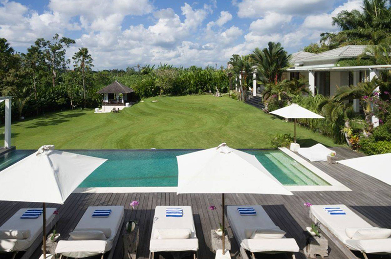 Pool and white pavilions at Pure Villa Bali, Canggu