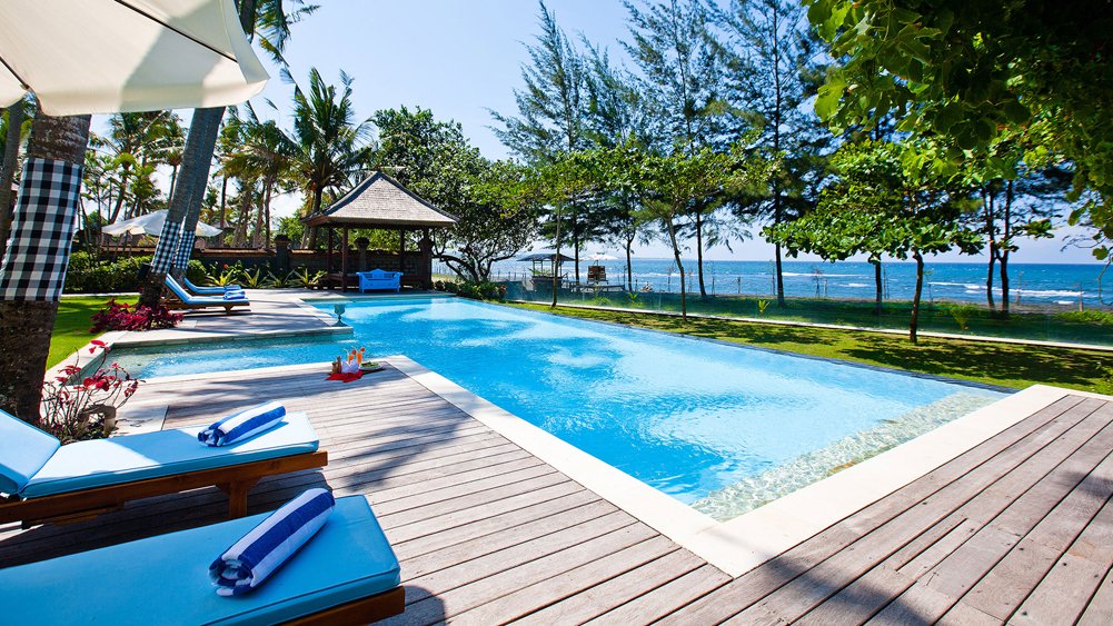 Villa Puri Nirwana's oceanfront lawn and pool facing the black-sand beach at Cucukan, Ketewel, on Bali's south-east coast