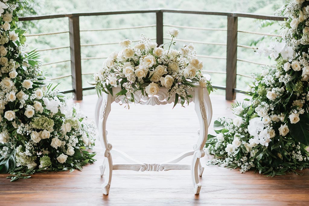 Interior of the bamboo Puspaka Sky Wedding Chapel with white chairs facing the valley view