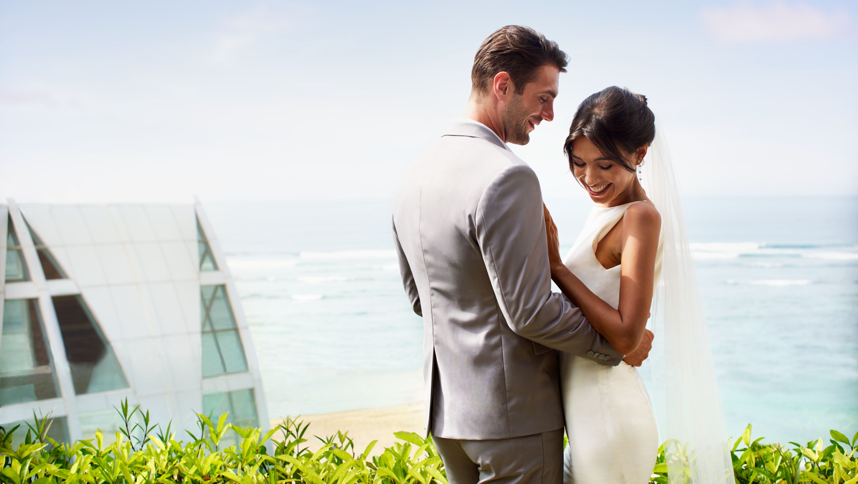 A couple at a clifftop sky villa with the ocean view at The Ritz-Carlton, Bali