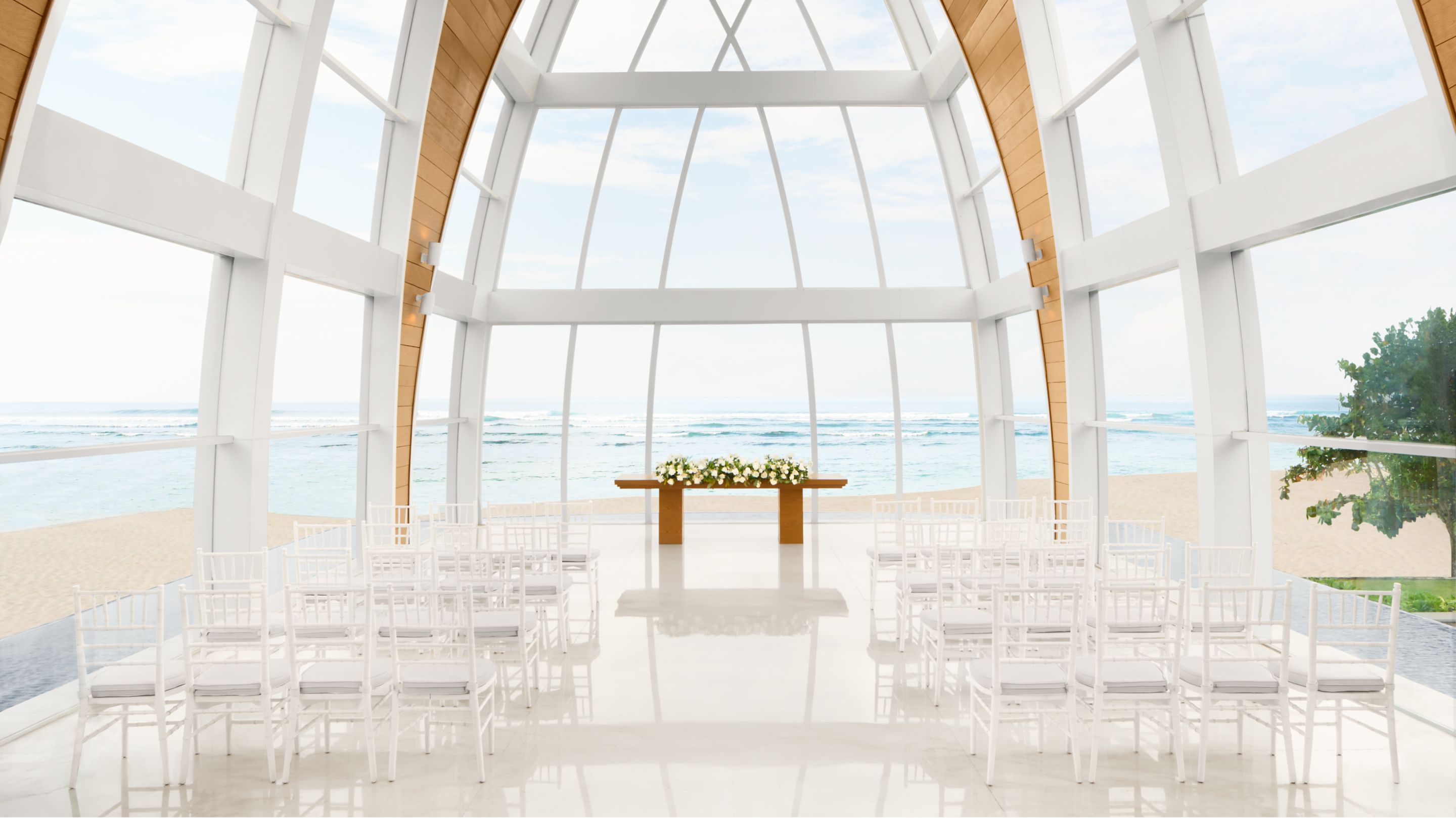 The glass wedding chapel on the cliff with the ocean beyond at The Ritz-Carlton, Bali in Sawangan