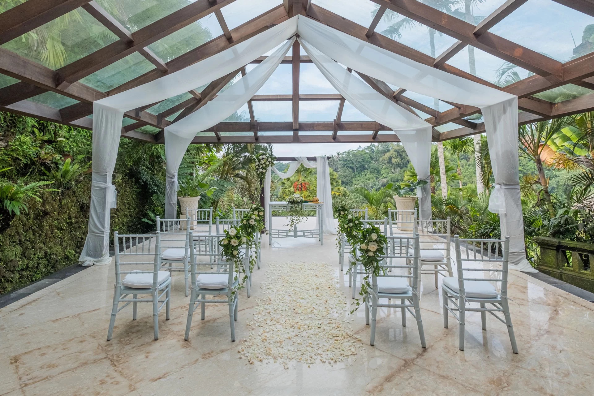 White pavilion with ceremony setup overlooking rice fields and jungle at The Royal Pita Maha, Ubud