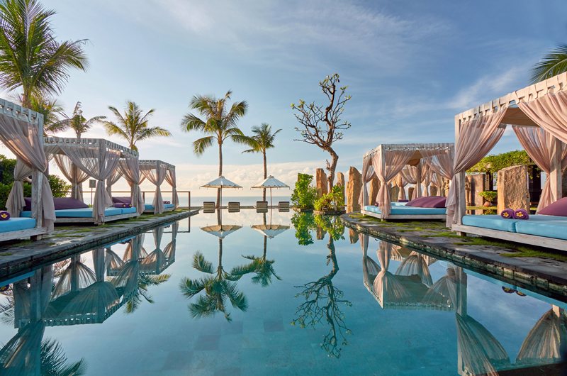 Beachfront pool and canopied daybeds facing the Indian Ocean at The Royal Purnama, Ketewel, southeast Bali