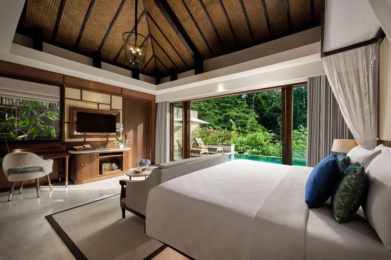 Luxury villa bedroom with pool view and rainforest surroundings at Samsara Ubud