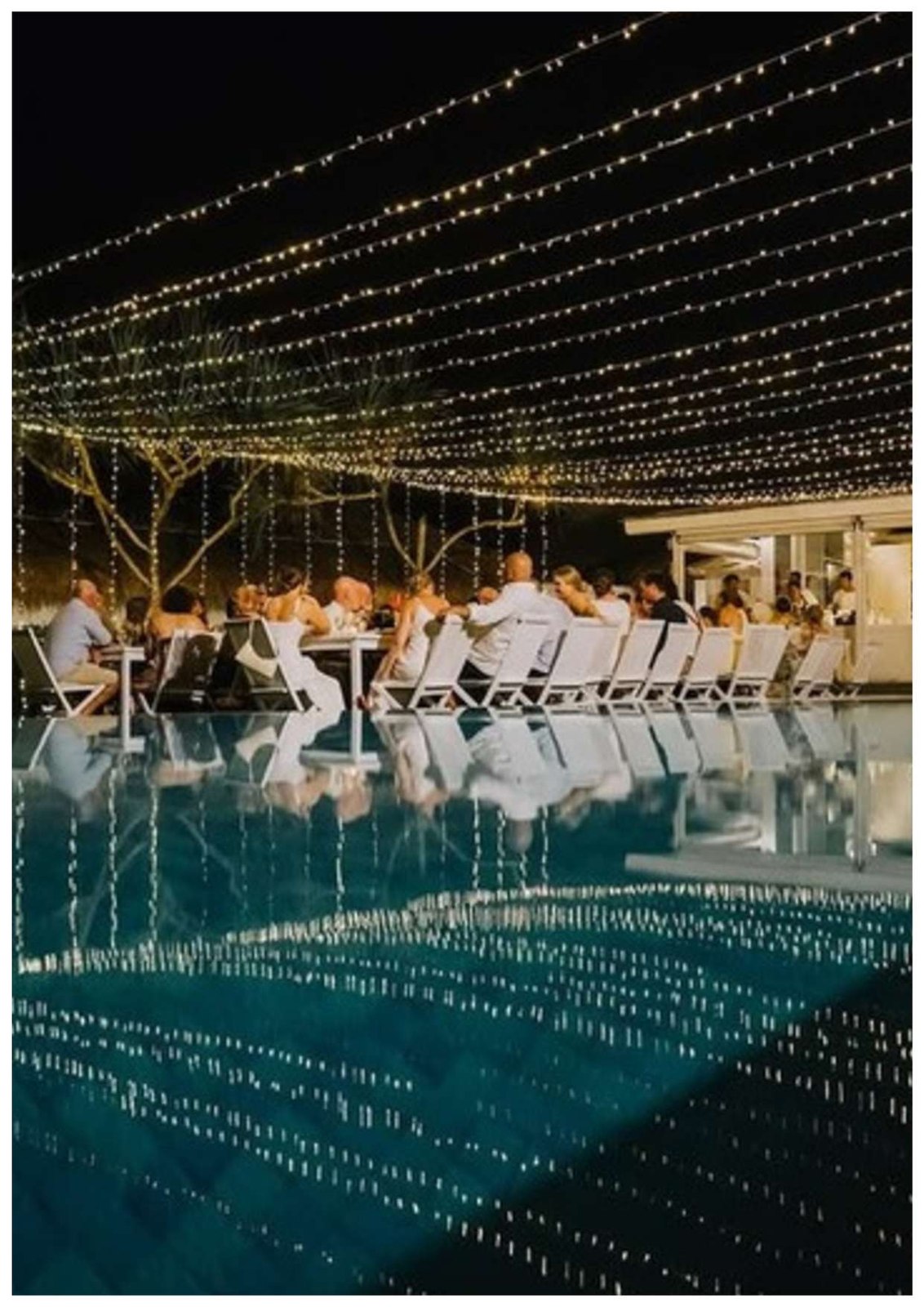 Wedding dinner under a canopy of fairy lights above the pool at Sandy Bay Beach Club, Nusa Lembongan, Bali