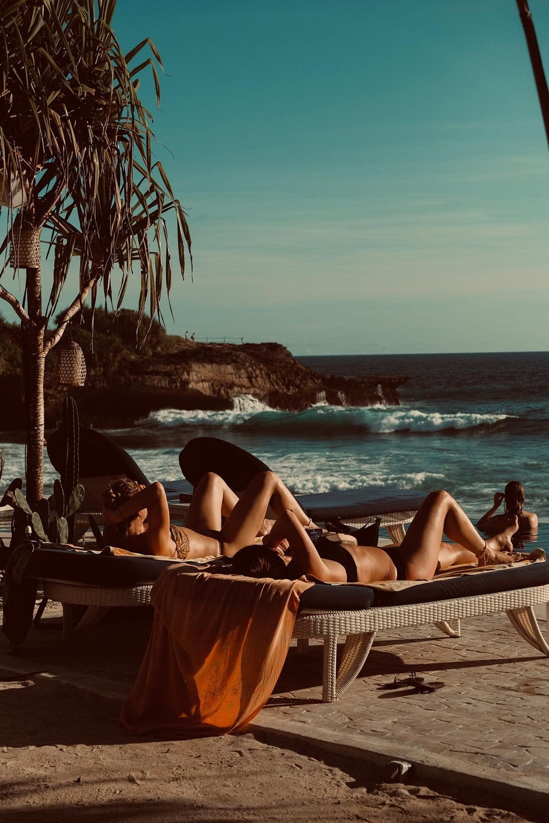 Sun loungers on the white sand below the cliffs at Sandy Bay, Nusa Lembongan, Bali