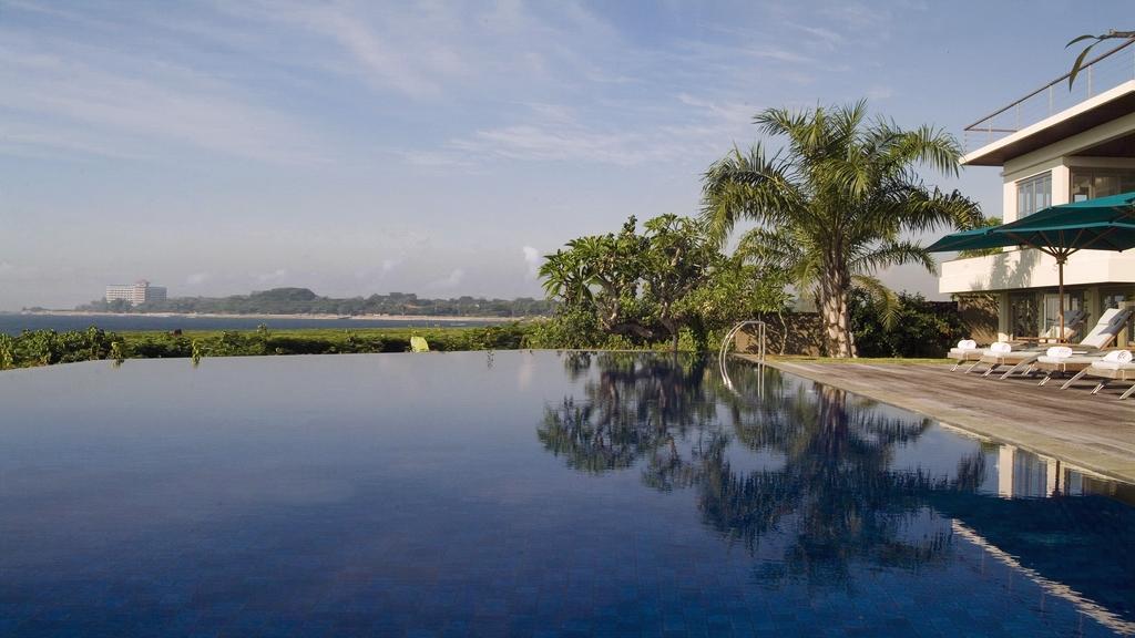 Infinity pool at Sanur Residence looking out over rice fields toward the sea
