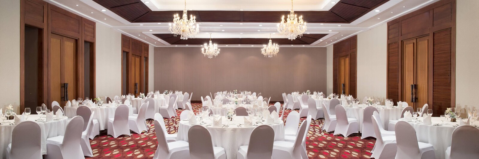 The Alamanda Ballroom set with round tables and chandeliers at Sheraton Senggigi Beach Resort, Lombok