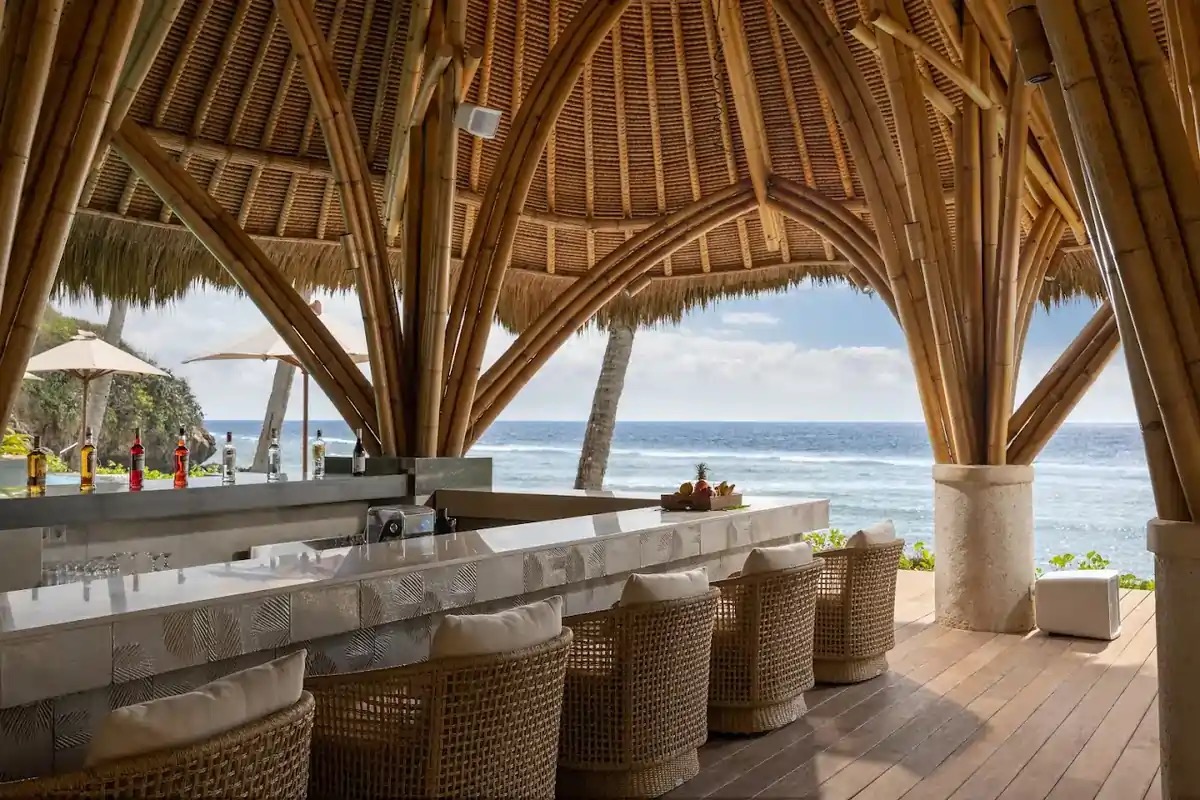 Bamboo-vaulted beachfront bar looking out over the reef at Silo Beach Club, Nusa Penida, Bali