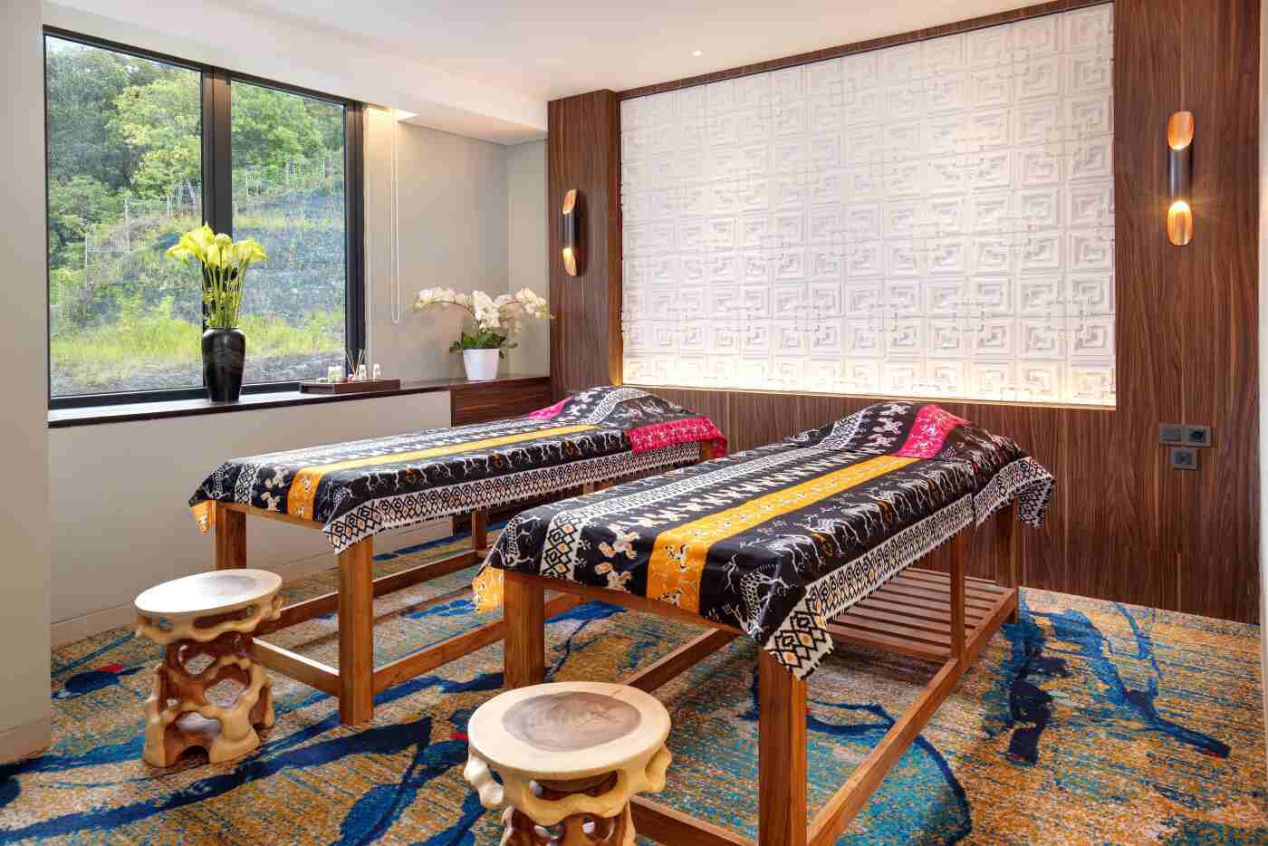 Spa treatment room with ikat-covered beds at Sima Hotel Sumba, Sumba