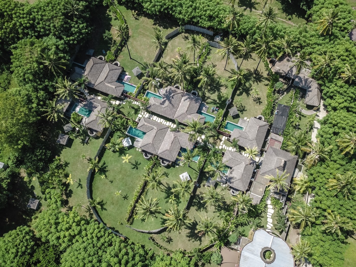Aerial view of the thatched villas, private pools and palm gardens of Slow Private Pool Villas, Gili Air