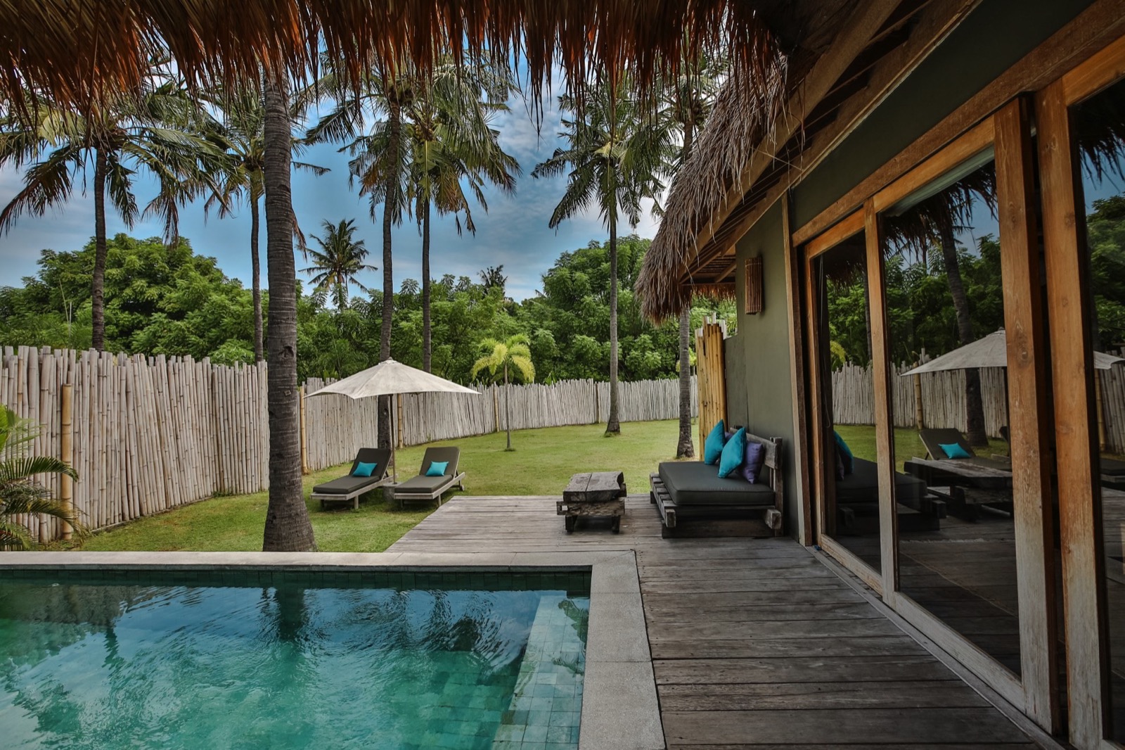 Private pool, lawn and bamboo-walled garden of a villa at Slow Private Pool Villas, Gili Air