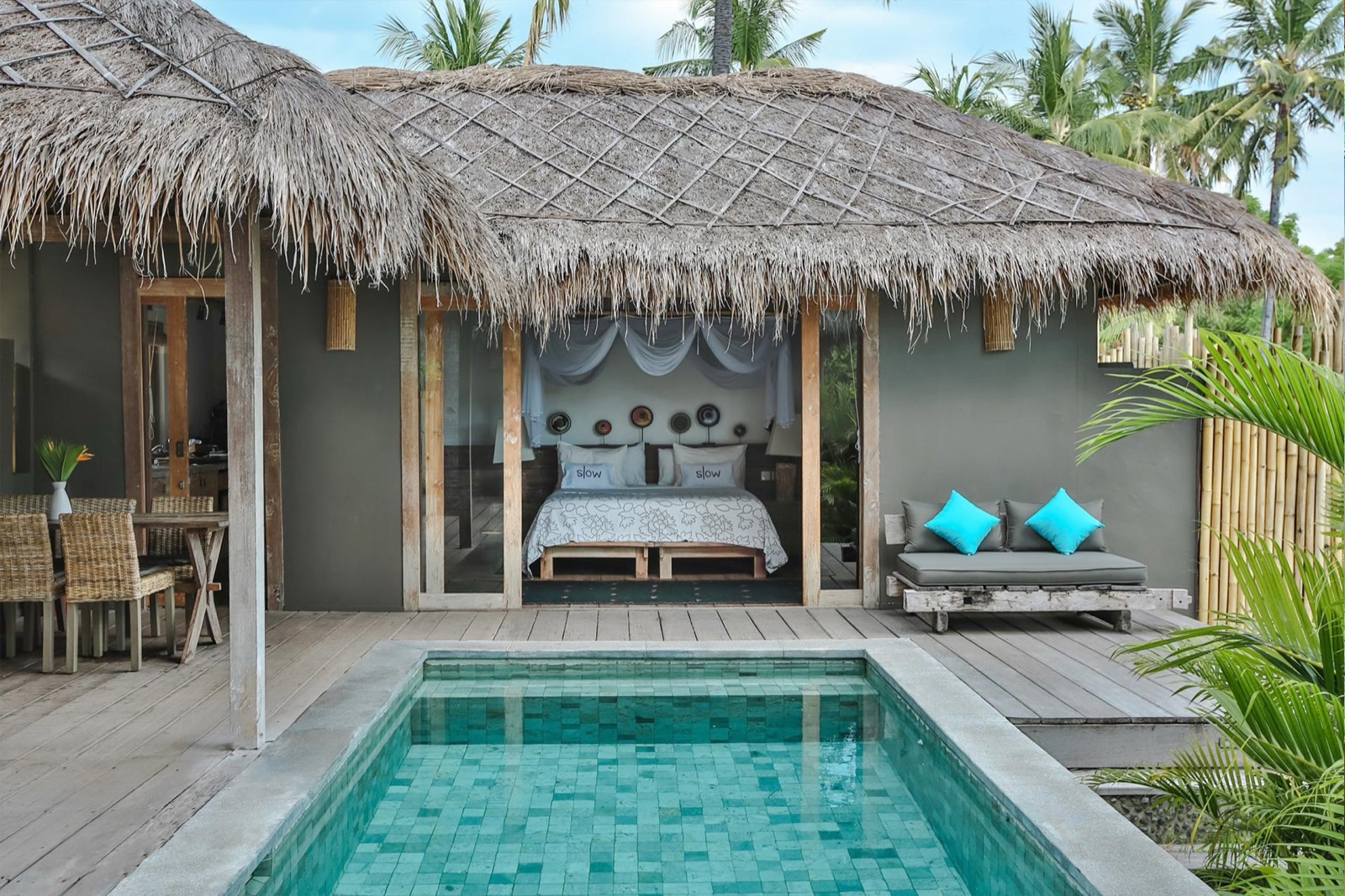 Thatched villa opening onto its own pool and timber deck at Slow Private Pool Villas, Gili Air