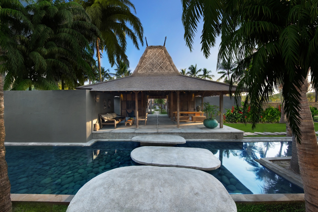 Thatched entrance pavilion with stepping stones across the pool at Slow Private Pool Villas on Gili Air, off Lombok