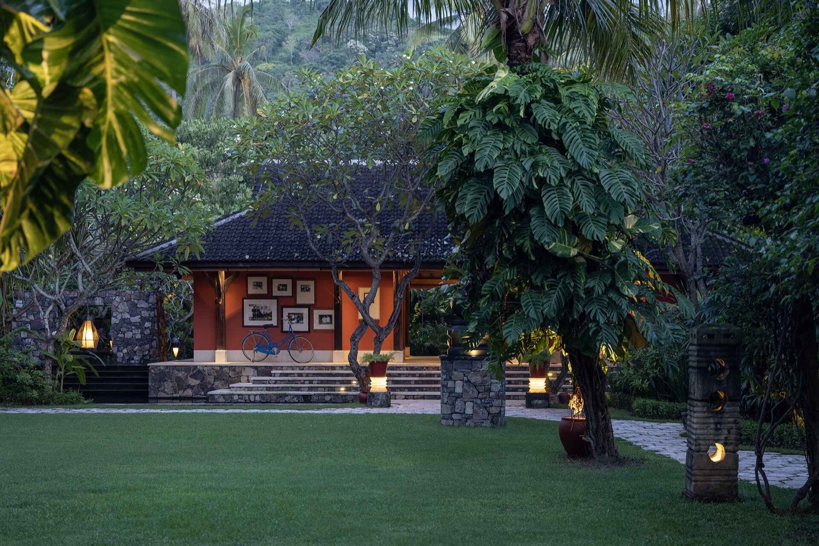 Lawn and lantern-lit pavilion hung with photographs in the grounds of Sudamala Resort, Senggigi, Lombok