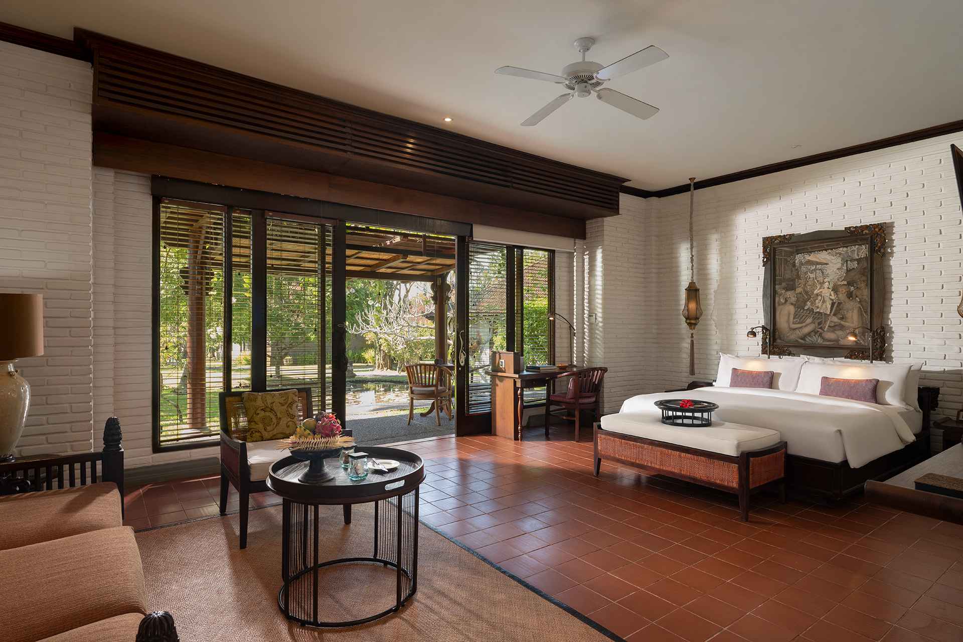 Villa bedroom at Tanah Gajah with Balinese art and garden doors