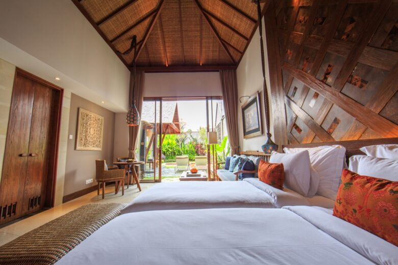 Garden view with pool and forest at Tejaprana Bisma in Ubud