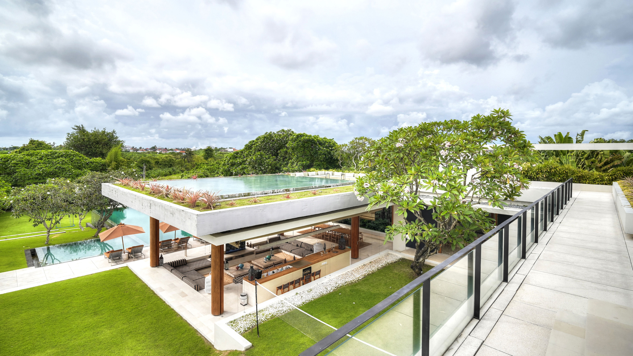 Rooftop terrace lounge at The Iman Villa with sweeping views over Pererenan