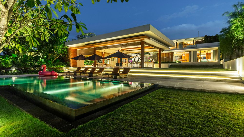 The Iman Villa's peaceful pavilion and gardens at dusk with soft evening light, Pererenan
