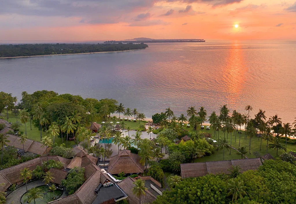 Aerial view at sunset over the gardens and bay of The Oberoi Beach Resort Lombok on Lombok's northwest coast