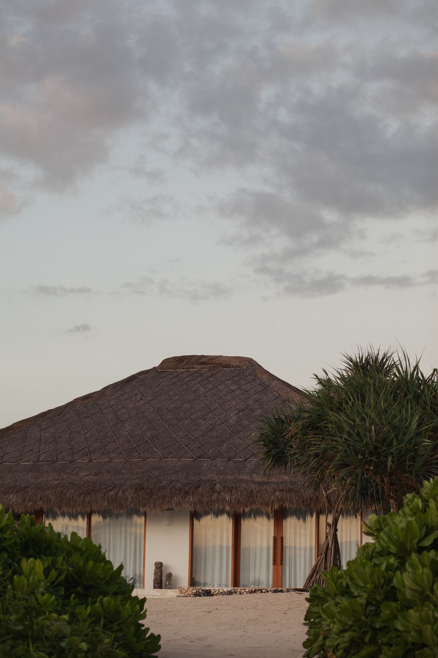 Beachfront villa with a thatched roof set back in the dune planting at The Sanubari, Sumba