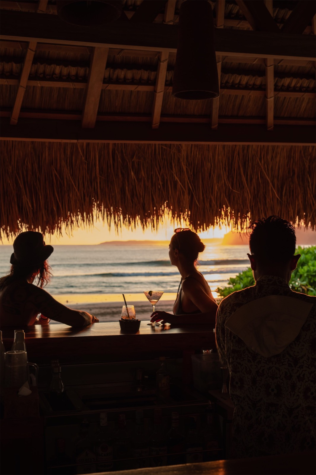 Guests watching the sun set from the bar at The Sanubari, Sumba