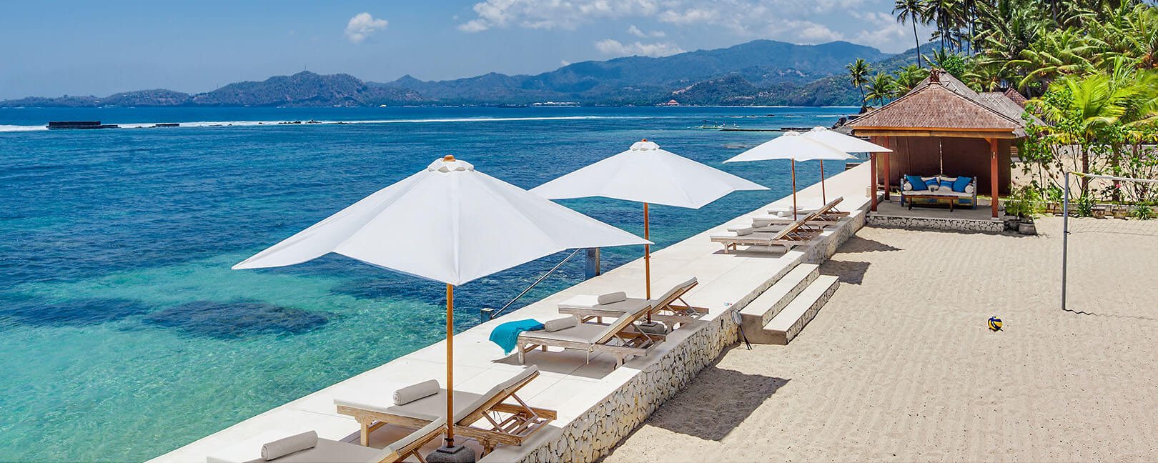 Beachfront pool and ocean deck at Tirta Nila Beach House near Candidasa on Bali's east coast