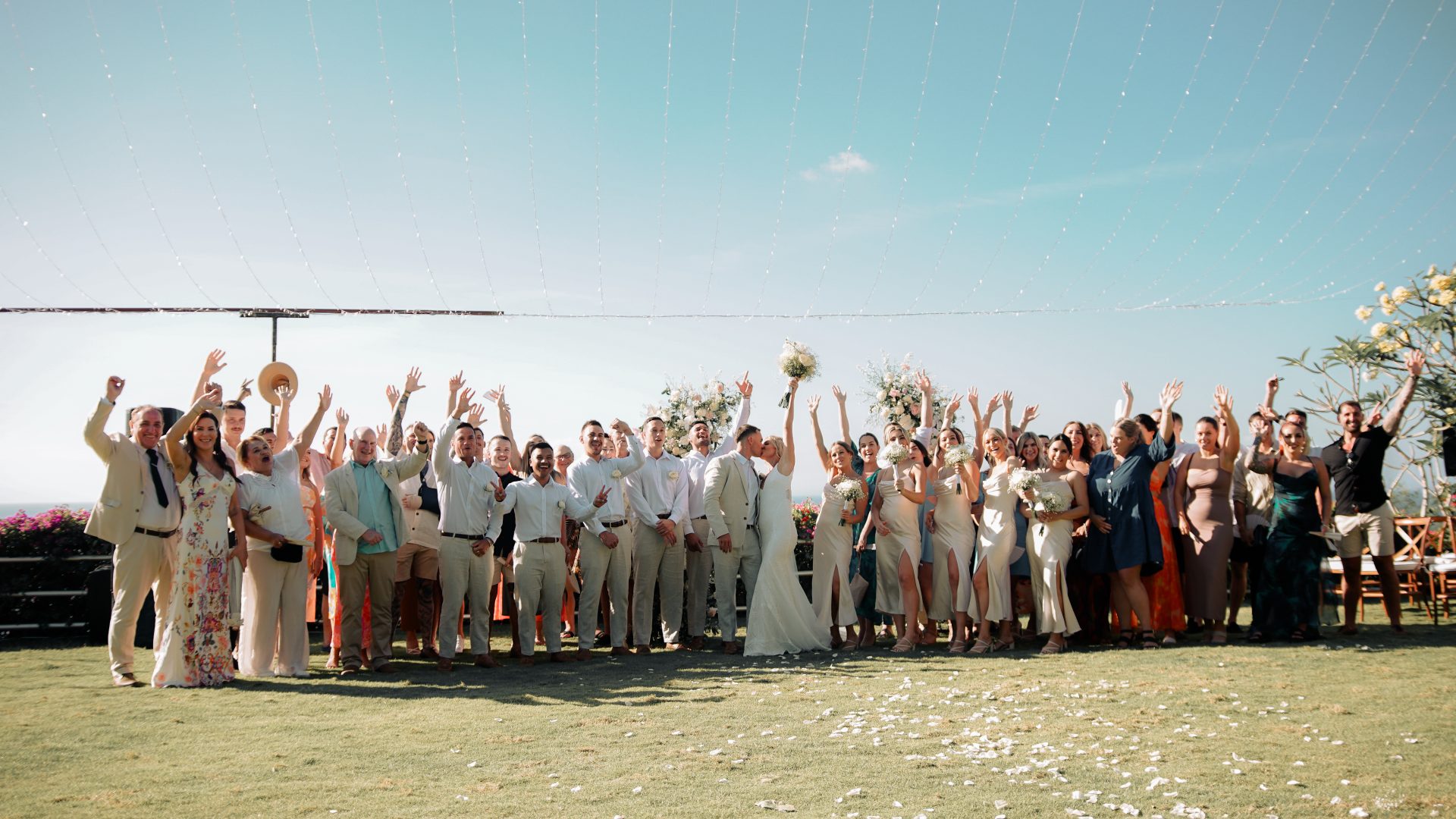 Clifftop lawn set for a ceremony at Uluwatu Cottages with the ocean beyond