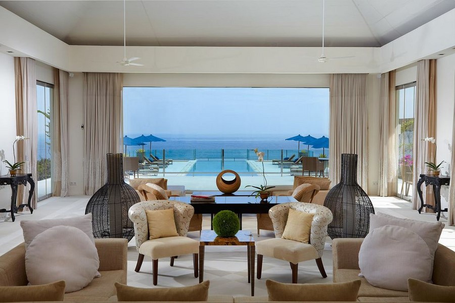 Villa Anugrah's great room with a cathedral ceiling opening onto the pool and ocean beyond