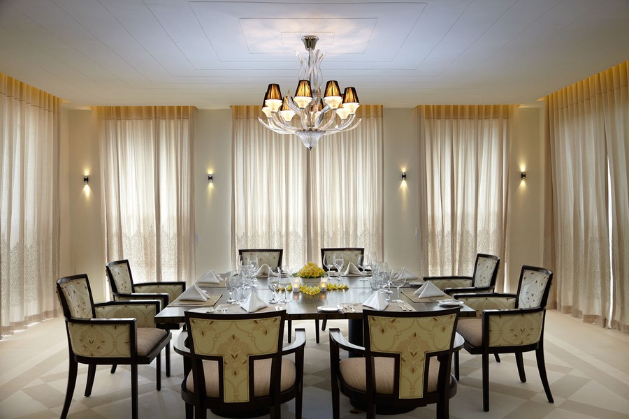 Formal dining room at Villa Anugrah set for a wedding dinner, seating ten under a chandelier
