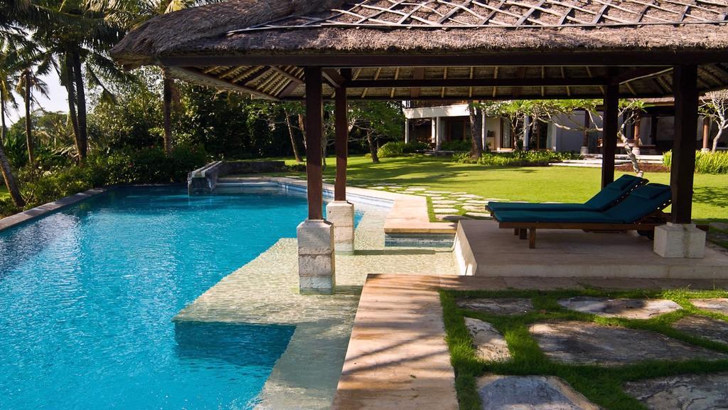 Poolside gazebo with loungers at Villa Arika, overlooking the garden and pool