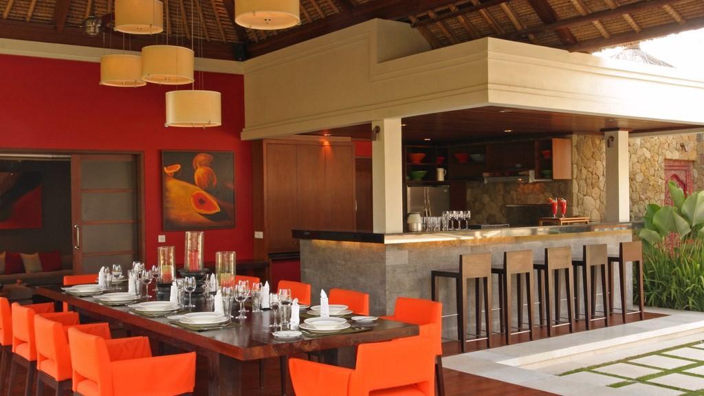 The open dining pavilion and bar at Villa Asta, set for a group dinner