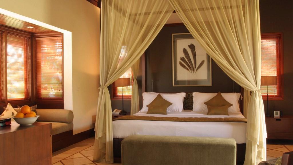 One of Villa Asta's bedrooms, with a draped four-poster bed