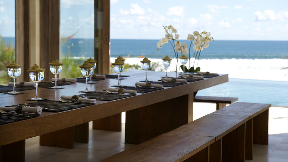 Ocean-view dining table set for guests at Villa Babar, west Bali