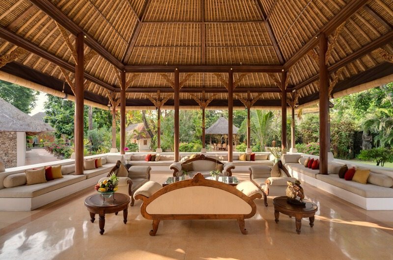 Open Balinese pavilion with lounge seating opening onto the garden at Villa Batujimbar, Sanur