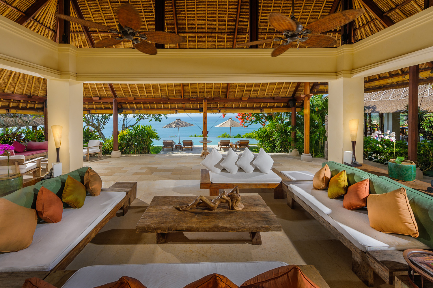 Open-air joglo living pavilion at Villa Bayuh Sabbha with ocean views between the columns