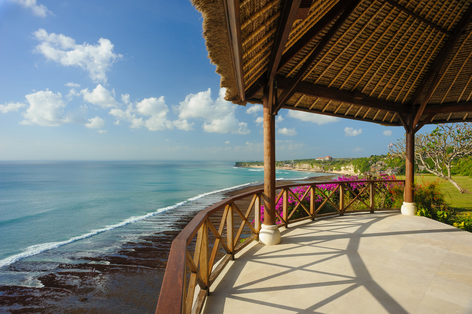 Curved clifftop balé at Villa Bayuh Sabbha with a thatch roof overlooking the Uluwatu coastline