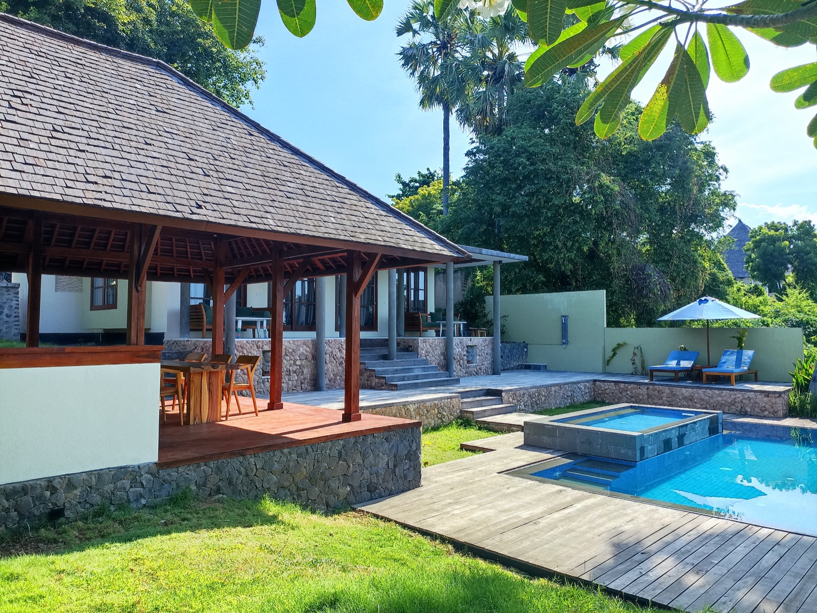 Private-pool villa with a timber dining bale and lawn at Villa Bukit Segara in Amed, east Bali