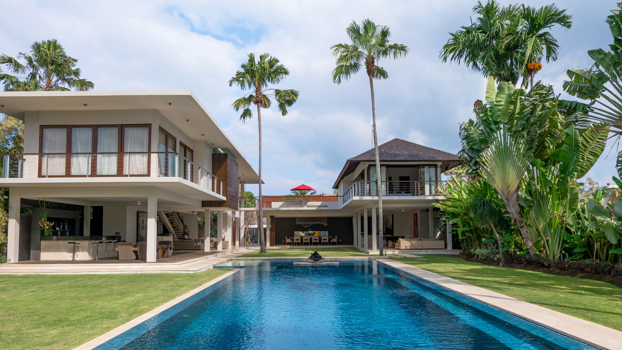 Villa Kalyani's pool and tropical garden in Berawa, Canggu, with the villa's open pavilions around it